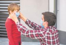 stockphotofatherputsamedicalmaskonhersoncoronavirusillnessinfectionquarantinemedicalmask1708207705.jpg