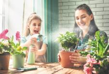 stockphotocutechildgirlhelpshermothertocareforplantsmomandherdaughterengagedingardeningnear609897284.jpg