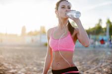 stockphotobeautifulfitnessathletewomanrestingdrinkingwaterafterworkoutexercisingonbeachsummer289300874-1534-1024.jpg