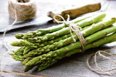 stockphotobunchoffreshasparagusonwoodentable396442531.jpg