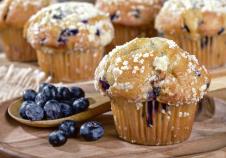 stockphotocloseupofablueberrymuffinandspoonfulofberriesonawoodenplatewithmuffinsinbackground1181068507.jpg