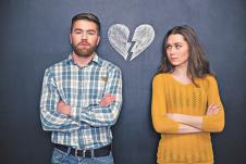 stockphotoportraitofyoungcoupleafterargumentstandingseparatelywithhandsfoldedoverblackboard373550518.jpg