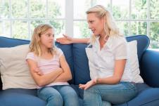 mala--stockphotowomanexplaininglittlegirlwhilesittingonsofaathome183774191.jpg