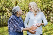 stockphotohappywomanexpectingababyholdingpregnancytestspendingtimewithfuturegreatgrandmother1186656877.jpg