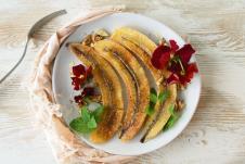 stockphotoflatlayofawhiteplatewithbakedbananaswithhoneyandcinnamonwalnutsdecoratedwith1757161160.jpg