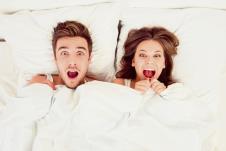 stockphotosurprisedfunnycoupleinlovelyinginthebed364449851.jpg