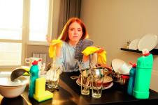 stockphotounhappyredhairedgingerbeautifulwomanwearingyellowgloveandwashingpilemountainsofdirty1648287037..sm.jpg