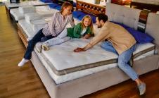 stockphotoayoungfamilywiththeirlovelydaughterlaydownonthebedtryingthemattressforsoftnessin2068612679.jpg