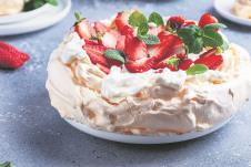 stockphotocakepavlovawithmeringuestrawberryandcreamselectivefocusimage1681348534.jpg