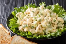 stockphotoorganicchickensaladwithceleryeggsseasonedwithsaucecloseuponaplateonthetable1527068429.jpg