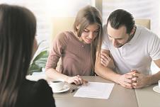 1008-stockphotosmilingfamilycouplereadingcontractualtermsbeforesigningcontractexaminingdocumentsto626698811.jpg