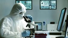 stockphotoscientistinprotectionsuitandmasksworkinginresearchlabusinglaboratoryequipment1713142675.jpg