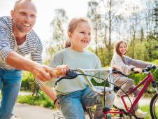 Otac uči ćerke da voze biciklu