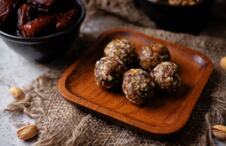 zdrave bombice od urmi, orašastih plodova i čokolade na drvenom poslužavniku, rustičan stil