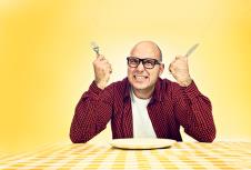 9-a-stockphotoangryhungrymansittingatdinnertablewithforkandkniferaised120009463.jpg