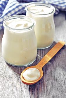 stockphotogreekyogurtinaglassjarswithspoonsonwoodenbackground161568965.jpg