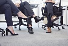 stockphotothreebusinesspeoplewithlegscrossedsittingonchairs158331716.jpg