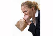 stockphotoblondwomanholdingabrownpaperbagovermouthwithadistraughtexpressionasifhavingapanic75051460.jpg