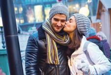 stockphotokissingyoungcouplewalkingonthestreetatwintertimebuyingroastedchestnuts497660191.jpg