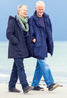 stockphotohappyelderlyseniorcouplewalkingonbeachhealthcarerecreation206008672.jpg