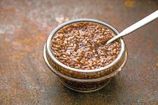 stockphotoglassbowlwithflaxseedsinthewateronthemetalbackgroundhorizontal557053009.jpg