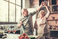 stockphotobeautifulseniorcoupleisdancingandsmilingwhilecookingtogetherinkitchen653481589.jpg