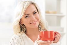 stockphotobeautifulsmilingwomanenjoyingthesmellofcoffeeinthemorning438828997.jpg