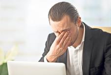 stockphotofrustratedbusinessmanfeelspainineyesbecauseofeyesightoverstrainafterlongcomputerwork639402220.jpg