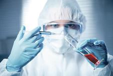 stockphotoresearcherinsafetyhazmatsuitpreparingasyringeforinjectionwithglasstesttube228757897.jpg