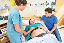 stockphotolovingmidadultmanwipingforheadofpregnantwomansforeheadinhospital162604949.jpg