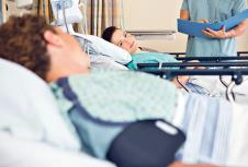 stockphotofemalepatientslookingateachotherwhilenursestandinginhospitalward173767034.jpg