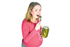 stockphotohappypregnantwomantastingpickleisolatedonwhite13319209.jpg