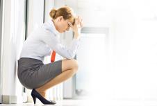 stockphotofulllengthsideviewofstressedbusinesswomancrouchingatofficehallway225474475.jpg