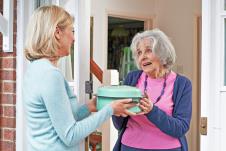 stockphotowomanbringingmealforelderlyneighbour518378194.jpg