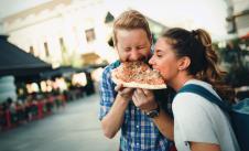 stockphotohappystudentseatingpizzaonstreet651937972.jpg