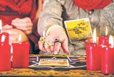 stockphotofortunetellerlayingtarotcardswithclientonpentagramcandlesareburning361944542.jpg