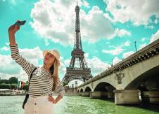 stockphotowomantouristselfieneartheeiffeltowerinparisundersunlightandblueskyfamouspopular607211708.jpg