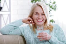 stockphotobeautifulmiddleagedwomandrinkingwaterinthemorningwomansfacecloseup1029888280.jpg