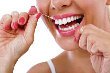 stockphotodentalflushwomanflossingteethsmiling216891070.jpg