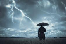 stockphotoabusinessmanholdinganumbrellainastorm26209639.jpg