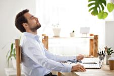 stockphotosatisfiedcalmbusinessmantakingbreaktorelaxfinishedworksittingatdeskenjoyingstressfree1296008464.jpg