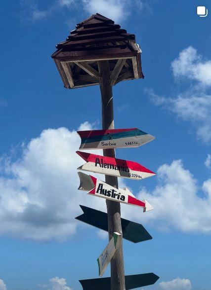 Drveni putokaz sa strelicama koje pokazuju pravac ka Srbiji, Nemačkoj i Austriji na Kubi