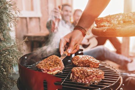 stockphotohappyyoungfriendsmakingbarbecueonporchwithbacklight614638979.jpg