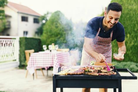 stockphotoyoungchefmakingbarbecueinhisgarden758185759.jpg