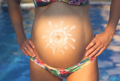 stockphotocloseuppictureofbellyofpregnantgirloverswimmingpoolwithbluewater296333195.jpg