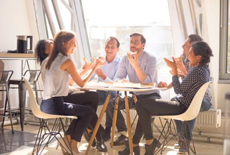 stockphotofriendlyhappydiverseteamworkerstalkinglaughingeatingpizzatogetherinofficecheerful1206996142.jpg