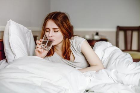 stockphotoyounghealthygirldrinkwaterinherbedonmorning399313543.jpg