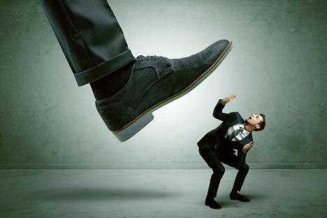 stockphotodemoralisedemployeesymbolizedbysmallmangettingtrampled762345799.jpg