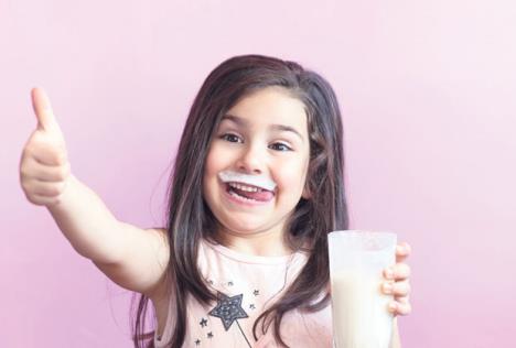 stockphotohappychildgirldrinkingyogurtwhiskersfromyogurt1065379319.jpg