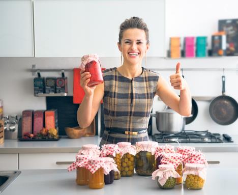 stockphotoportraitofhappyyounghousewifeamongjarswithhomemadefruitsjamandpickledvegetables257211397.jpg